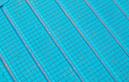 Abstract background close up of blue non slip surface with square relief and sand perfect for...