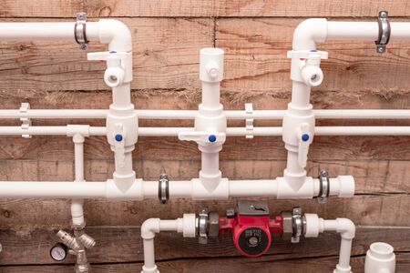 Heating and water system in a private house using white plastic pipes.