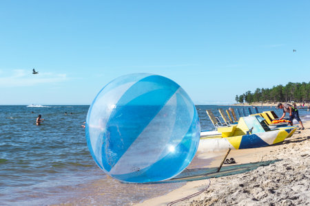 Goryachinsk, Russia, August 15, 2020: Empty zorb on the inshore waves, water activities, Zorbing extreme attraction for beach vacationersのeditorial素材