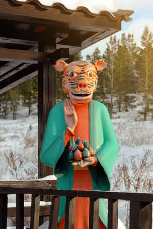 Human tiger statue with buddhist gesture at winter, new year 2022 symbol of traditional eastern calendar, animal sign of chinese zodiac of asian culture, no people vertical imageの写真素材