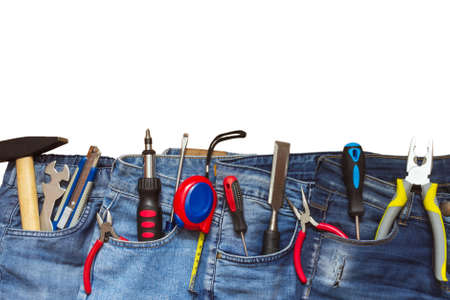 Patriotic holiday concept of labor day, top view of jeans with tools in pockets isolated on white background, flat lay with copy spaceの写真素材