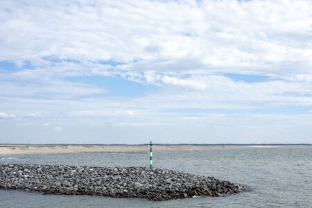 The Marker Wadden, the newest bit of the Netherlands, artificial archipelago in development located in the Markermeer, a lake in the Netherlands, wetland made, with blue clouded sky.の写真素材