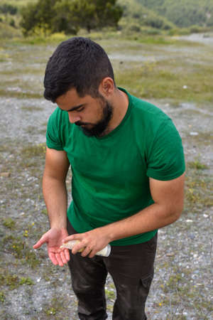 Man putting sunscreen in the handsの写真素材