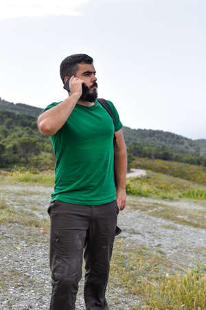Man using his mobile phone in the natureの写真素材