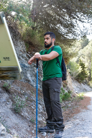 Man looking for information in a panel during a hiking dayの写真素材