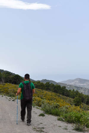 Hiking man walking on a trailの写真素材