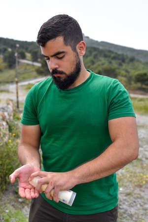 Man putting sunscreen in the handsの写真素材