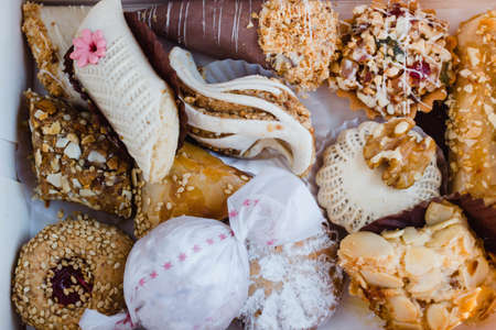 Petits fours marocains (translated as moroccan sweets) seen from a top view. It includes briouates and almond cookies.の写真素材
