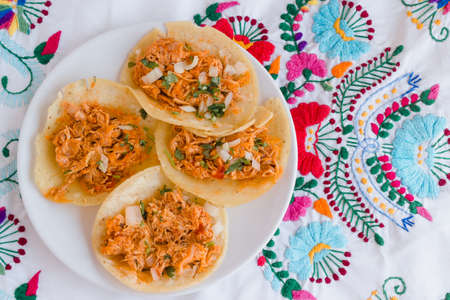 Authentic tinga de pollo tacos on embroidered mexican tableclothの写真素材