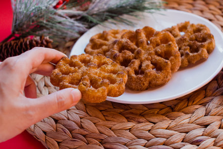 Hand holding buÃ±uelos, sweet cookie with cinnamon eaten in Mexico for christmasの写真素材