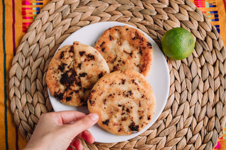 Hand picking gordita de chicharrÃ³n presado, traditional mexican foodの写真素材