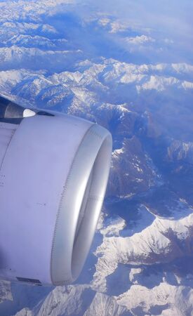 Close up of a jet engine over the Alpsの写真素材