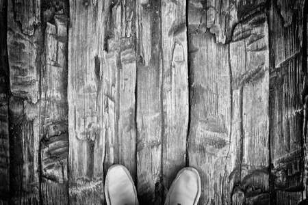 man foots on black and white wooden board backgroundの写真素材