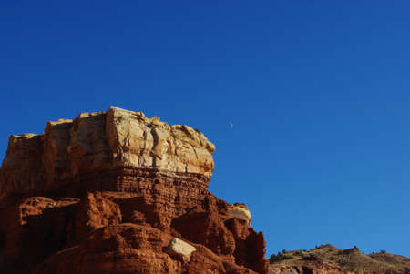 Red and white rock mountain with moon, Capitol Reef National Park, Utahの写真素材