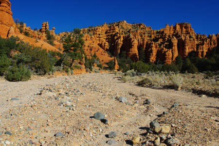 Dry river bed and fantastic orange rock towersの写真素材