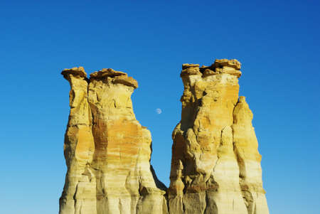 Rock towers and moonの写真素材