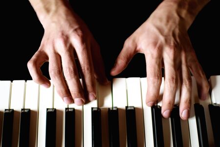 close up to pianist hands while playingの写真素材