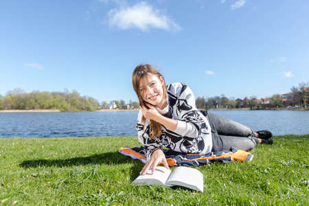 Student laughs while learning in the camera during nice weatherの写真素材