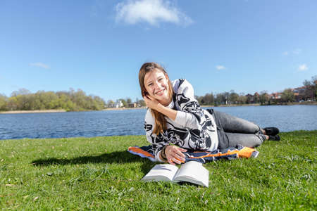 Student laughs while learning in the camera during nice weatherの写真素材