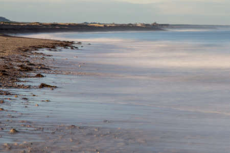 Receding tide at Spey bay shoreの写真素材