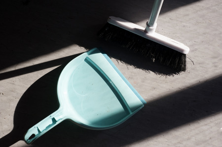 broom and dustpan in diagonal lightの写真素材
