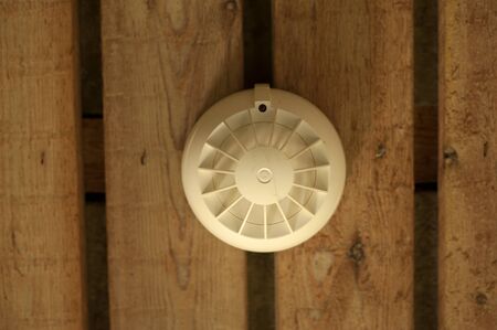 Smoke detector on wooden backgroundの写真素材