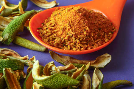 close up of indian achar masala with dry mango  slice inm a spoonの写真素材