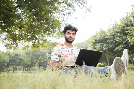 college boy work on laptopの写真素材