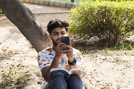 college boy text by phoneの写真素材