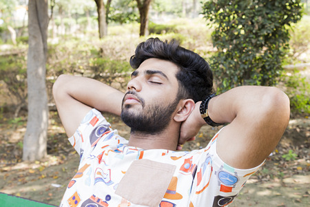 college boy relaxing on benchの写真素材
