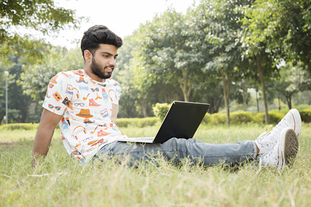 college boy work on laptopの写真素材