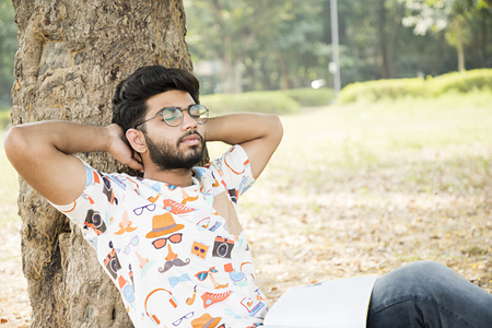 college boy relaxing in a parkの写真素材