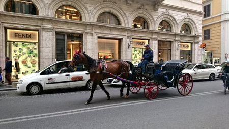 Rome, Italy - Apr 03 2018: A house carrying a carriage with a coachman driving on a busy streetのeditorial素材