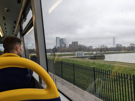 London, UK - 03.01.2022: A male passenger looking out the window on the upper floor of a...