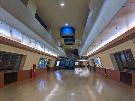 Kaohsiung, Taiwan - 12.02.2022: A near-empty interior of the airplane view deck facing the runway at Kaohsiung International Airport with moving walkways at night during the pandemicのeditorial素材