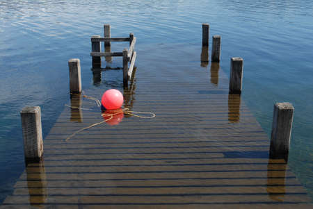 Wood pier and buoy in Patagonia's lakeの写真素材