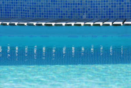 Swimming pool border reflected on water
