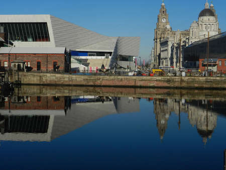 Liverpool waterfront with old and new buildings and reflectionon water.のeditorial素材