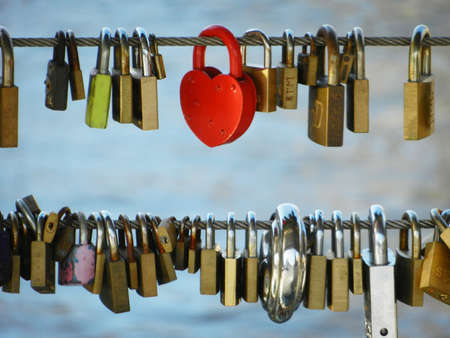 Metal Padlocks attached as love symbol on bridgeのeditorial素材