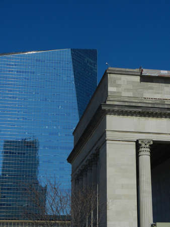 New and old buildings contrast with blue skyの写真素材