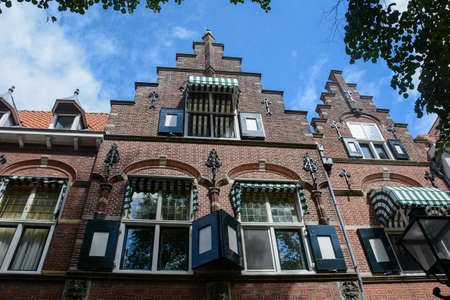 Typical house facade in the old town ZIERIKZEE on Zeeland / Netherlands with blue skyの写真素材