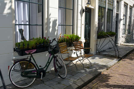 Typical Holland - bicycle leaning against a house facade on Zeeland in the Netherlandsの写真素材