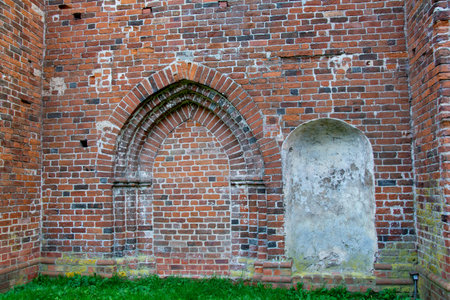 Old stone wall with closed brick arch on a historic buildingの写真素材