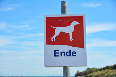 Sign with a dog and the German word "End" on the beach, information that dogs are no longer allowed on the beach after the signの写真素材