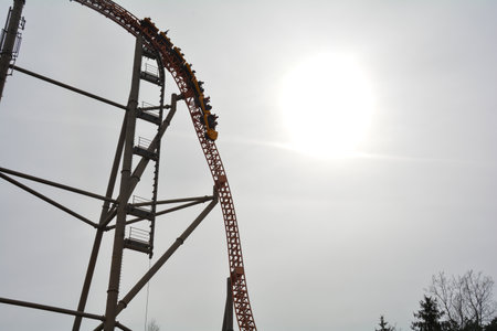 Roller coaster with full carriages in the amusement parkの写真素材