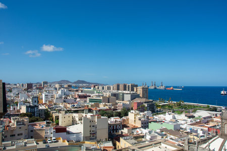 Panoramic view from above of the capital and part of the harbor in Las Palmas Gran Canaria in Spain with blue skyの写真素材