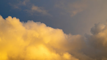 Big yellow cloud in the sky in the evening sunの写真素材