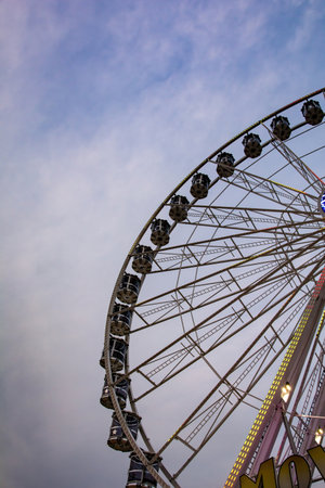 Part of a Ferris wheel with lighting in twilight