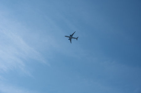 An airplane from below with a lot of skyの写真素材