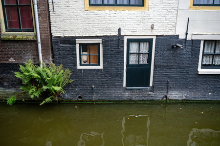 House facades on a water canal in the old town of Alkmaar in the Netherlandsの写真素材